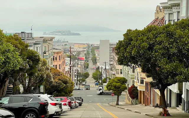 Photograph looking down Taylor Street in San Francisco, with a large portion of the city and the bay visible.