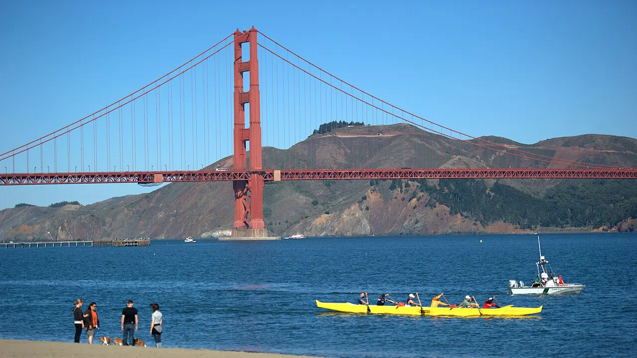 Golden Gate Bridge seen from Crissy Field, San Francisco, California. People canoeing in the foreground.
