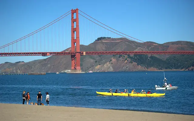 Golden Gate Bridge seen from Crissy Field, San Francisco, California. People canoeing in the foreground.