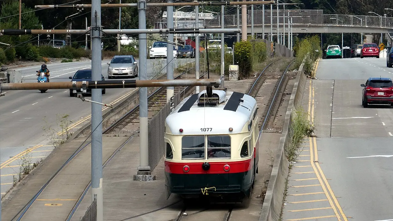 Muni streetcar #1077 near Glen Park pulling out for service on the F Market & Wharves in August 2024
