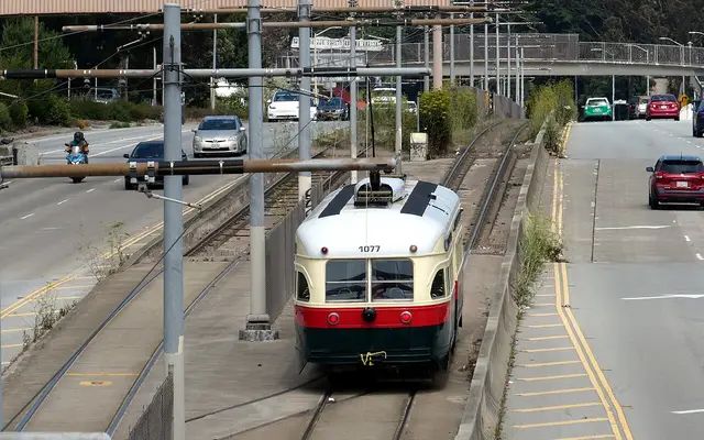Muni streetcar #1077 near Glen Park pulling out for service on the F Market & Wharves in August 2024
